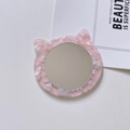 Close-up of a cat-shaped acetate vanity mirror with pink marble texture on a white background - 8cm*7cm*0.5cm / Pink
