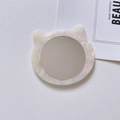 Macro detail of cat-eared portable makeup mirror with white pearlescent texture finish - 8cm*7cm*0.5cm / Mermaid Color