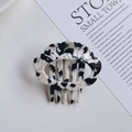 Close-up of cloud-shaped acetate hair clip with black and white marble pattern texture - Black White Cow Print