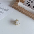 Macro shot of small star hair claw with gold finish and white mother of pearl inlay - Star Mini Claw