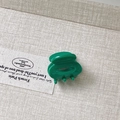 Mini green acetate hair claw clip with glossy finish for girls on wooden background - Green