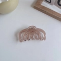 Detailed view of pink translucent hair claw clip with octopus-like teeth on white background - Half-Arc Style