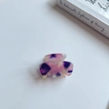 Detailed macro view of a purple marble acetate mini hair claw clip with France handmade engraving - Purple Pink