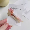 Pink cat-shaped acetate hair clip with pearls and rhinestones on a display card - Gradient Purple