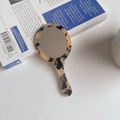 Detailed close-up of tortoiseshell acetate hand mirror on vintage book background - 12.5cm*5.8cm / Light Leopard