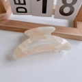 Large orange marble acetate hair claw clip with elegant gold lettering on a white desk - Large Arc Claw Clip