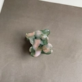 Detailed macro view of acetate bear claw clip with marble texture and gold lettering - Multicolor Marble Bear Style