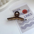 Large dark brown claw clip with metallic spring for thick hair in a minimalist setting - Small / Brown