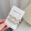 Set van twee vintage haarclips met marmerpatroon en een elegante goudkleurige metalen basis - Gespikkeld Wit