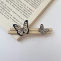 Close-up of French vintage acetate butterfly hair claw clip on an open book - Beige Two Butterflies