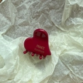 Macro shot of glossy red heart hair claw with golden France Handmade engraving - Red