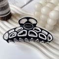 Classic French black and white acetate hair claw clip with cutout geometric patterns - White