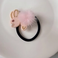 Detailed shot of a pink plush rabbit hair tie with gold accents and soft pom pom texture - Pink