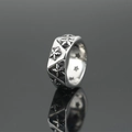 Vintage stainless steel ring with embossed floral pattern and star cutouts on dark background - US 7 / Steel