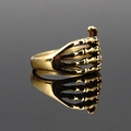 Gothic punk skeleton hand ring in antique gold finish for men on black mirror surface - US 7 / Antique Gold