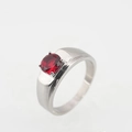 Minimalist silver ring featuring a round faceted red gemstone in a classic four-prong setting - US 7 / Polished Ruby Style