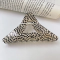 Detail of acetate hair claw showing check pattern and FRANCE handmade gold branding - Black White Polka Dot