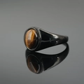 Polished black titanium steel ring featuring a round tiger eye stone inlay with wood grain - Black Base Tiger Eye Stone
