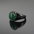 Minimalist black titanium ring featuring a polished round green agate gemstone inlay - Black Base Green Stone