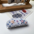 White acetate shark hair clip with blue diamond pattern and pink star accents - Silver Star