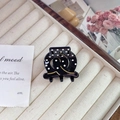 Elegant black acetate hair claw with white polka dots and golden hollow double loop design - Black Small