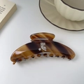 Elegant tortoiseshell acetate hair claw with rhinestone logo detail on white desk - Tortoiseshell Brown (5007155584057) / 4# Coffee Tortoiseshell