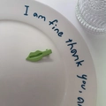 Cute green lip-shaped hair clip with matte finish on a decorative white porcelain plate - Green