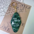 Detailed close-up of dark green marble acrylic keychain with gold ring and white quote engraving - Gold Accessories / Green