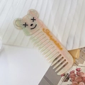 Dettaglio del pettine in acetato a forma di orso con strass lucidi e scritta Surprise - Mickey (Rosa Verde)