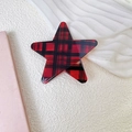 Detailed view of a red and black plaid star hair clip on a minimalist white background - Red Plaid