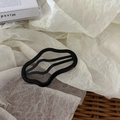 Minimalist black wave-shaped hollow hair clip made of glossy resin on aesthetic background - Cloud Style / Cloud Shape Black