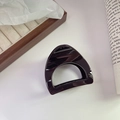 Close-up of deep purple glossy hair claw clip with minimalist hollow D-shaped design - Dark Red