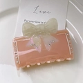 Pink acetate shark hair clip with cream bow and rhinestones in variant colorway - Pink