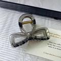 Elegant bow-shaped hair claw clip in translucent smoky grey acrylic material - Transparent Gray