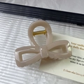 Elegant milk tea beige bow hair claw clip with glossy finish and gold metal spring - Light Coffee