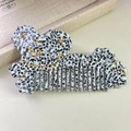 Detail of a cow print acetate hair comb featuring a golden smiling animal face design - 4# Spotted Black