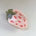 Detailed view of sweet strawberry claw clip with sparkling rhinestones and cream finish - Pink
