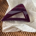 Close-up of a hollow triangular hair claw in translucent deep purple acrylic resin - Cherry Red
