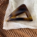 Macro detail of amber tortoiseshell acrylic hair claw clip with cutout triangle design - Matte Amber