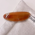 Detailed close-up of amber acetate barrette featuring gold Barrette La France lettering - Caramel color
