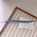 Detail of blue and purple marbled acetate hair pin with France engraving on jewelry tray - Iridescent Blue Purple