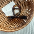 Elegant amber tortoiseshell bow hair claw clip in a brown woven basket display - 6# Bright Yellow