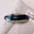 Tortoiseshell acetate barrette with marbled brown texture and gold lettering detail - Textured Coffee