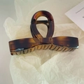 Large amber tortoise shell hair claw clip with elegant ribbon bow design and polished finish - Bright Yellow