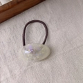 Detail of oval cream resin hair tie with shimmering sequins and Sanshine logo - Mermaid White