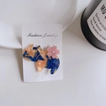 Detailansicht einer Acetat-Haarklammer in Katzenform mit Marmortextur und kleiner Blume - Blau