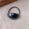 Elegant oval acetate hair tie with brown elastic band on a minimalist textured fabric - Dark Green Black