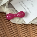 Elegante fermaglio per capelli a fiocco magenta con scritte dorate su fondo raffinato - Rosso