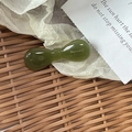 Deep green acetate bow hair clip with gold logo on a vintage rustic background - Candy Bow Knot / Green
