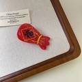 Detail of red acetate lucky bag hair clip with traditional gold Fu character for New Year - Lucky Bag
